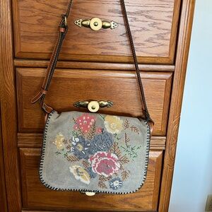 Patricia Nash leather denim floral, cross, stitch tapestry saddle bag.